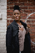 woman in brown tube top under black jacket